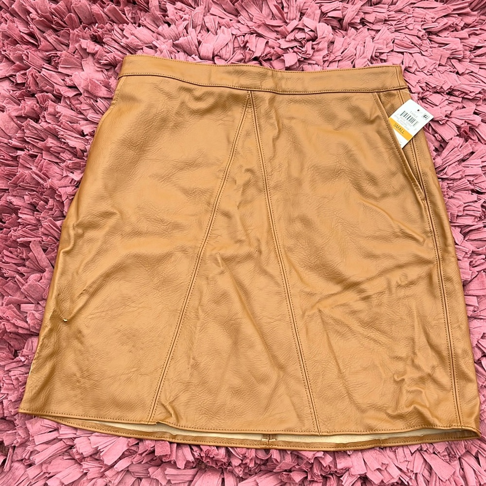 Women’s Faux Leather Skirt. Size small with tag on. Minimal tears in fabric.